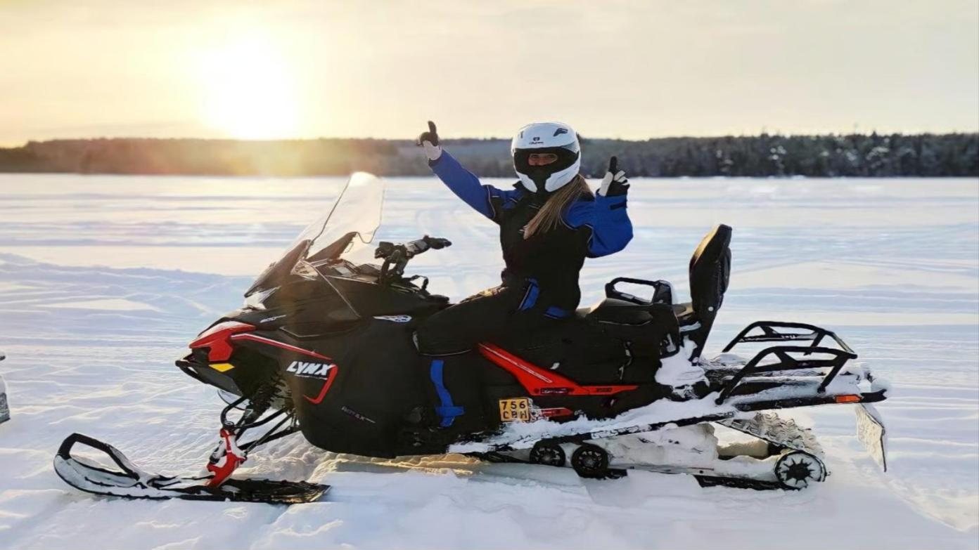 rider waving, low sun over the lake